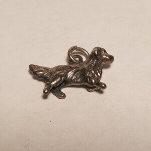 Cute small vintage silver dog charm.